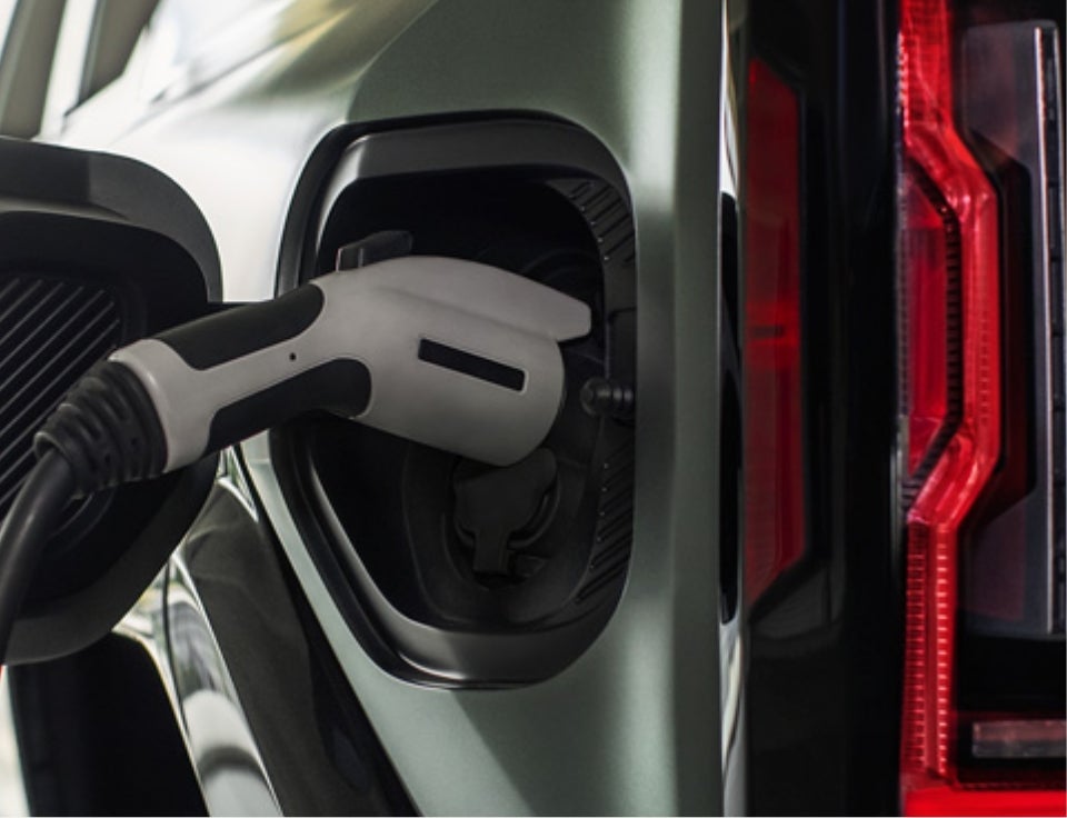Close up of charging port with charger plugged in on a GMC Hummer EV SUV - Heritage GMC of Evanston in Evanston WY